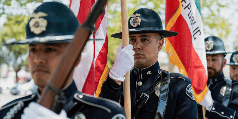 Hemet Police Honor Guard marching with the state and nation's flags