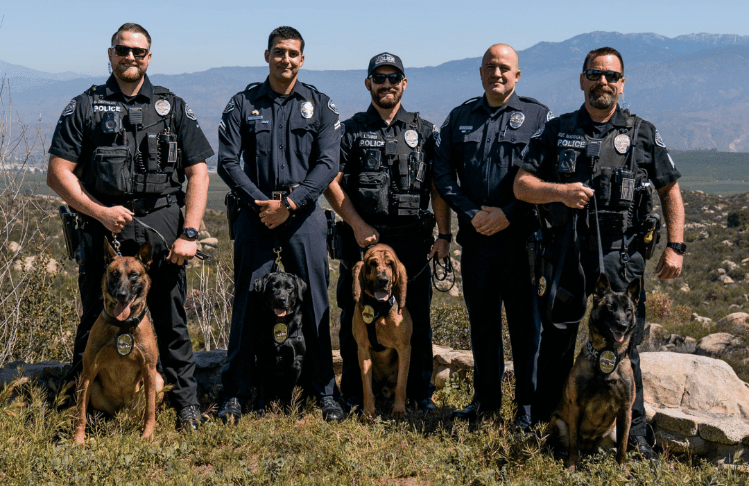 The Hemet Police K-9 Team poses with their dogs